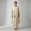 A-line top with flowing wide-leg palazzo pants and a draped cape. Suit - Classic Off White